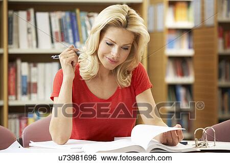 Stock Photograph - Senior student working in library. Fotosearch