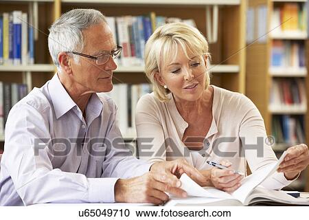 Stock Image - Senior students working in library. Fotosearch