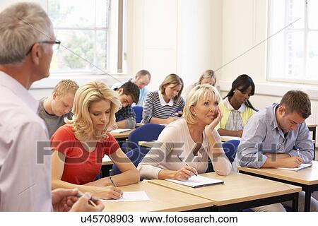 Stock Image - Senior tutor teaching class. Fotosearch
