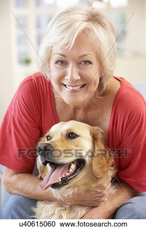 Senior woman at home with dog View Large Photo Image Stock Image - Senior woman at home with dog. Fotosearch