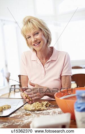 Senior Woman Baking Cookies In Kitchen View Large Photo Image Stock Image - Senior Woman Baking Cookies In Kitchen. Fotosearch