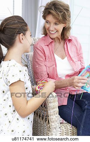 Senior woman doing cross stitch with granddaughter View Large Photo Image Stock Image - Senior woman doing cross stitch with granddaughter. Fotosearch