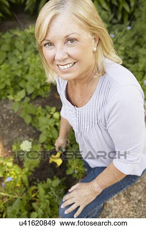 Stock Photo - Senior woman gardening. Fotosearch