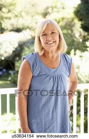 Picture - Senior woman in garden. Fotosearch