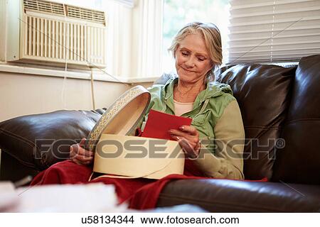 Senior Woman Keeping Warm Under Blanket With Memory Box View Large Photo Image Picture - Senior Woman Keeping Warm Under Blanket With Memory Box. Fotosearch