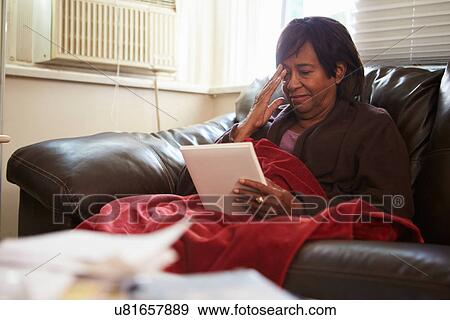 Senior Woman Keeping Warm Under Blanket With Photograph View Large Photo Image Stock Photo - Senior Woman Keeping Warm Under Blanket With Photograph. Fotosearch
