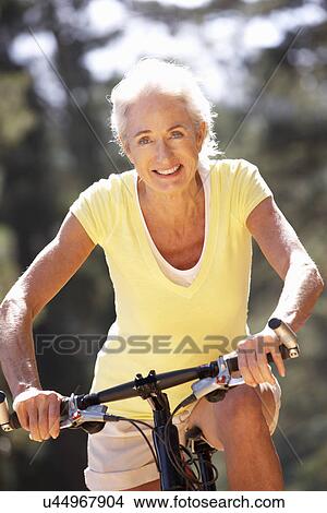 Senior woman on country bike ride View Large Photo Image Picture - Senior woman on country bike ride. Fotosearch