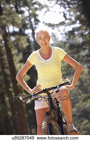 Stock Photo - Senior woman on country bike ride. Fotosearch