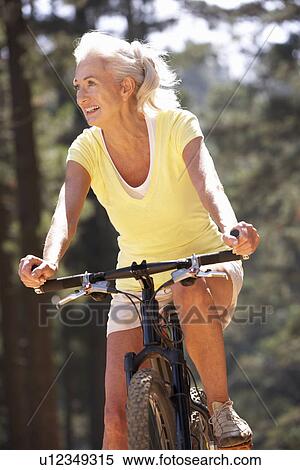 Senior woman on country bike ride View Large Photo Image Stock Photography - Senior woman on country bike ride. Fotosearch