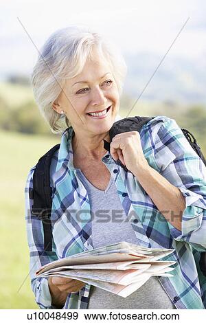 Stock Photo - Senior woman on country walk. Fotosearch