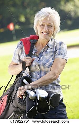Senior woman on golf course View Large Photo Image Stock Image - Senior woman on golf course. Fotosearch