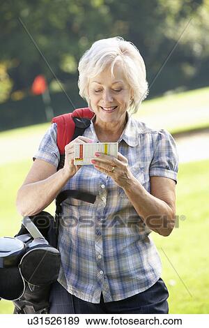 Senior woman on golf course View Large Photo Image Stock Photo - Senior woman on golf course. Fotosearch