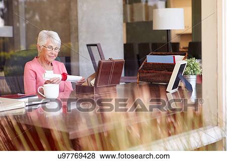 Senior Woman Putting Will Into Box View Large Photo Image Stock Photo - Senior Woman Putting Will Into Box. Fotosearch