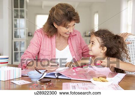 Senior woman scrapbooking with granddaughter View Large Photo Image Stock Image - Senior woman scrapbooking with granddaughter. Fotosearch