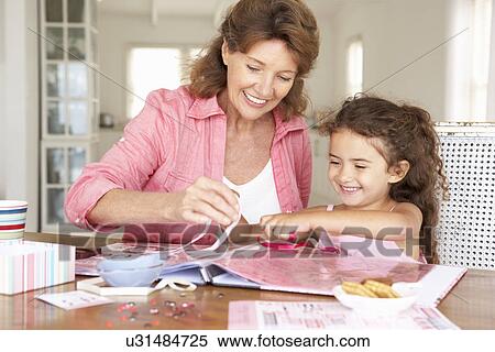 Senior woman scrapbooking with granddaughter View Large Photo Image Stock Photography - Senior woman scrapbooking with granddaughter. Fotosearch