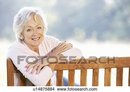 Senior woman sitting outdoors View Large Photo Image Picture - Senior woman sitting outdoors. Fotosearch