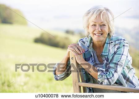 Stock Photo - Senior woman sitting outdoors. Fotosearch