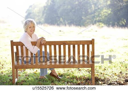 Senior woman sitting outdoors View Large Photo Image Stock Photograph - Senior woman sitting outdoors. Fotosearch