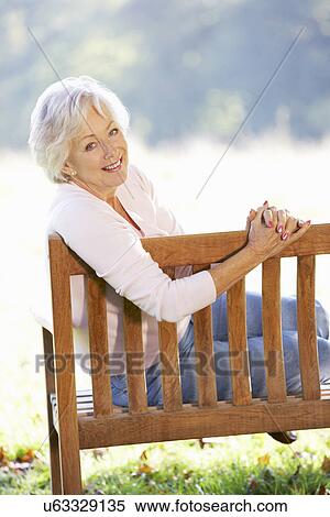 Senior woman sitting outdoors View Large Photo Image Stock Photography - Senior woman sitting outdoors. Fotosearch