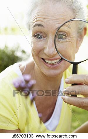 Senior woman with magnifying glass View Large Photo Image Stock Image - Senior woman with magnifying glass. Fotosearch