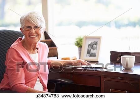 Senior Woman Writing Memoirs In Book At Desk View Large Photo Image Stock Image - Senior Woman Writing Memoirs In Book At Desk. Fotosearch