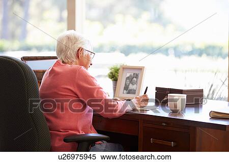 Senior Woman Writing Memoirs In Book At Desk View Large Photo Image Stock Photography - Senior Woman Writing Memoirs In Book At Desk. Fotosearch