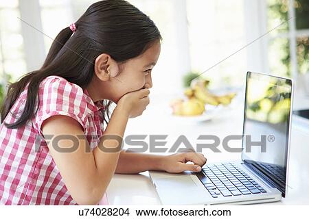 Shocked Asian Child Using Laptop At Home View Large Photo Image Picture - Shocked Asian Child Using Laptop At Home. Fotosearch