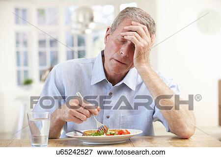 Sick older man trying to eat View Large Photo Image Stock Photo - Sick older man trying to eat. Fotosearch