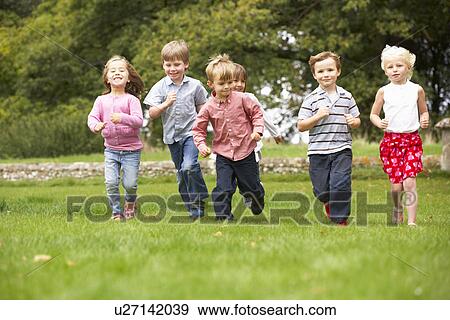Small group young children running in park View Large Photo Image Stock Photo - Small group young children running in park. Fotosearch