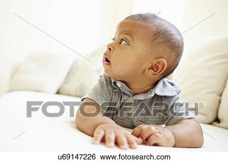 Smiling Baby Boy Lying On Tummy At Home View Large Photo Image Stock Photograph - Smiling Baby Boy Lying On Tummy At Home. Fotosearch