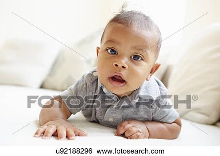Smiling Baby Boy Lying On Tummy At Home View Large Photo Image Stock Photograph - Smiling Baby Boy Lying On Tummy At Home. Fotosearch