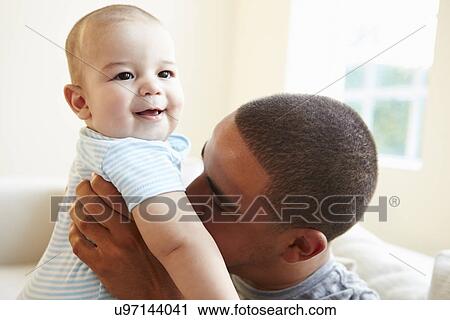 Smiling Father Playing With Baby Son At Home View Large Photo Image Stock Image - Smiling Father Playing With Baby Son At Home. Fotosearch