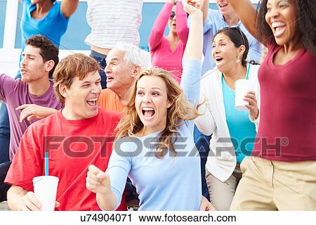 Stock Image - Spectators Celebrating At Outdoor Sports Event. Fotosearch