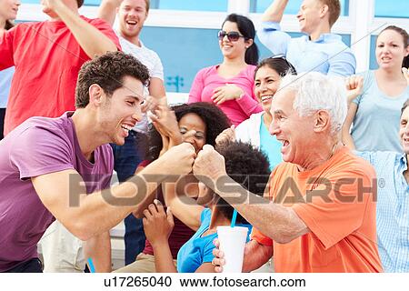 Stock Image - Spectators Cheering At Outdoor Sports Event. Fotosearch