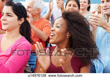 Stock Photo - Spectators Cheering At Outdoor Sports Event. Fotosearch