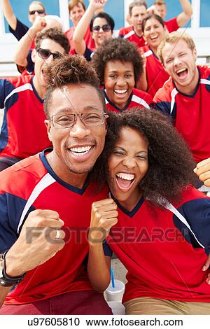 Stock Image - Spectators In Team Colors Watching Sports Event. Fotosearch
