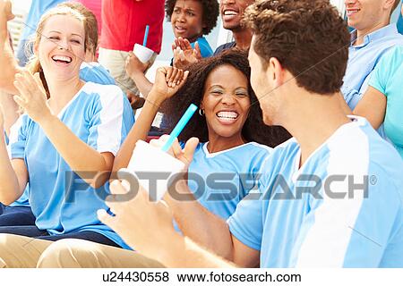 Stock Photo - Spectators In Team Colors Watching Sports Event. Fotosearch