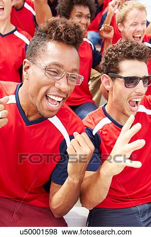 Stock Photo - Spectators In Team Colors Watching Sports Event. Fotosearch