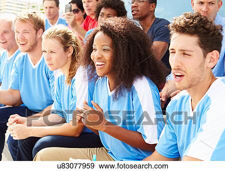 Stock Photo - Spectators In Team Colors Watching Sports Event. Fotosearch