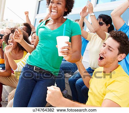 Sports Spectators In Team Colors Celebrating View Large Photo Image Stock Image - Sports Spectators In Team Colors Celebrating. Fotosearch