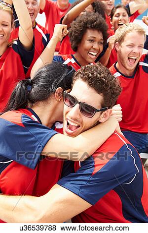 Sports Spectators In Team Colors Celebrating View Large Photo Image Stock Photo - Sports Spectators In Team Colors Celebrating. Fotosearch
