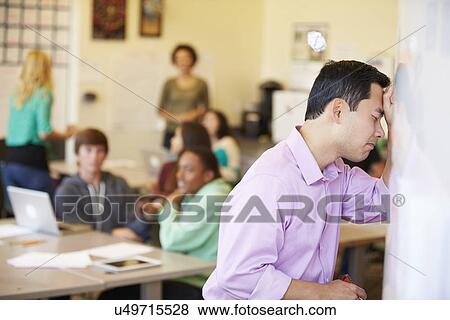 Stock Photo - Stressed High School Teacher Trying To Control Class. Fotosearch