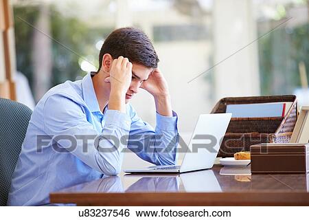 Stressed Teenage Boy Using Laptop On Desk At Home View Large Photo Image Stock Photograph - Stressed Teenage Boy Using Laptop On Desk At Home. Fotosearch
