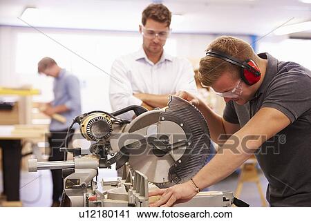 Student And Teacher In Carpentry Class Using Circular Saw View Large Photo Image Stock Image - Student And Teacher In Carpentry Class Using Circular Saw. Fotosearch