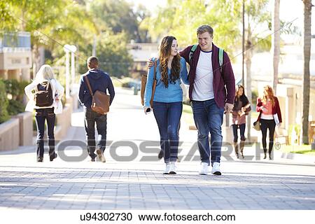 Student Couple Walking Outdoors On University Campus View Large Photo Image Stock Image - Student Couple Walking Outdoors On University Campus. Fotosearch