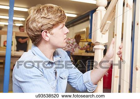 Stock Image - Student In Carpentry Class Working On Staircase. Fotosearch