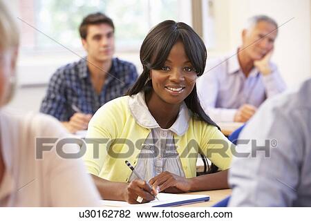 Stock Image - Student in class. Fotosearch