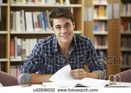 Stock Image - Student working in library. Fotosearch