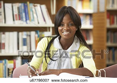 Stock Photo - Student working in library. Fotosearch