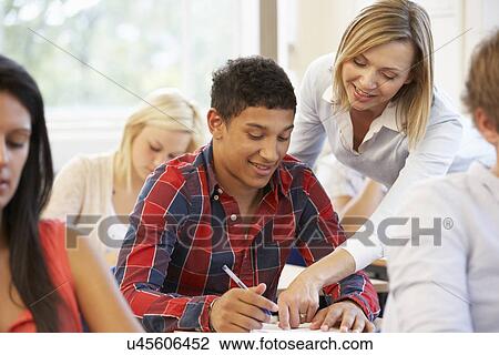 Stock Image - Students and tutor in class. Fotosearch